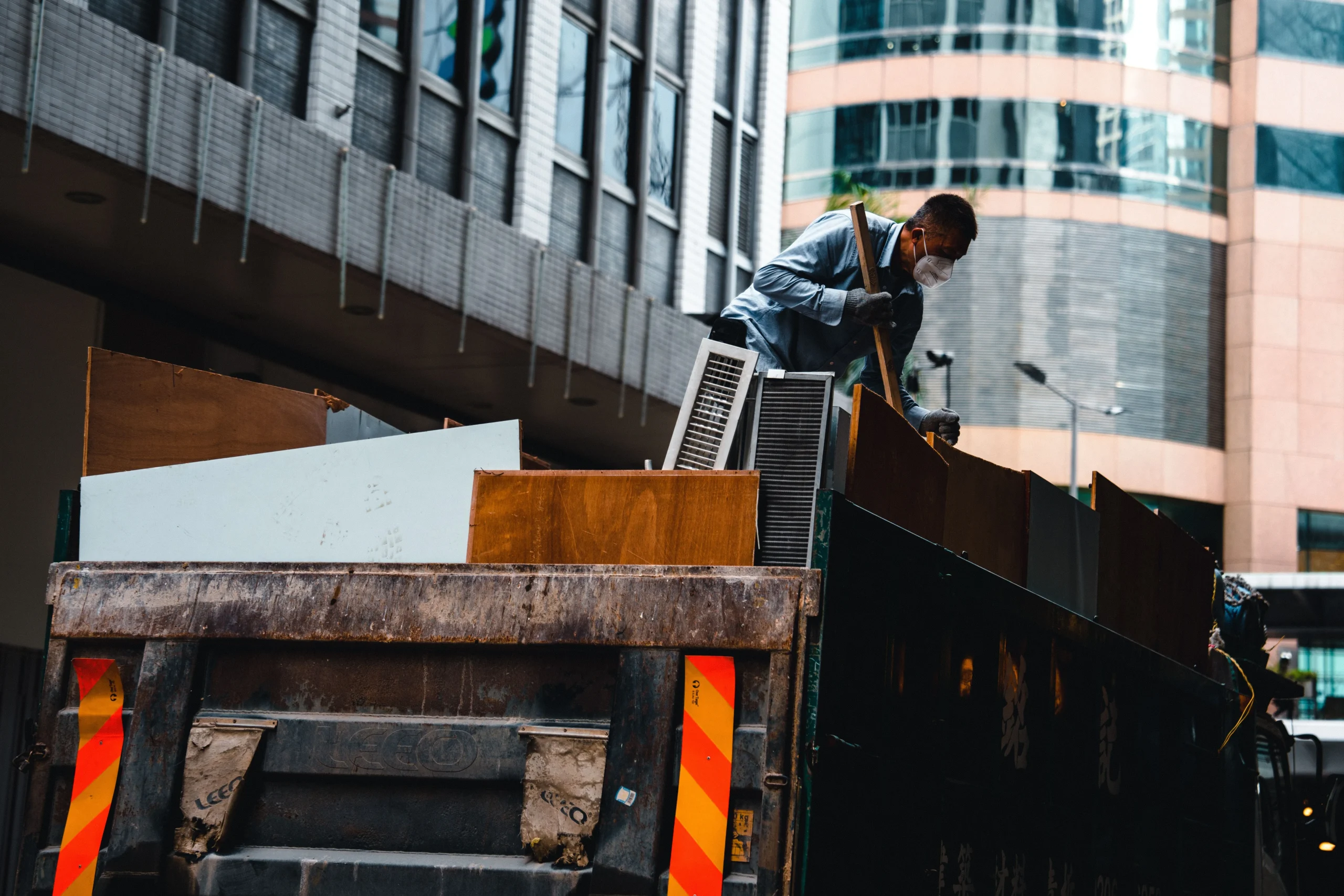 Crew loading furniture and debris into a truck on a junk removal job